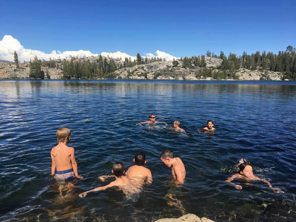 backpacking crew swimming in the lake