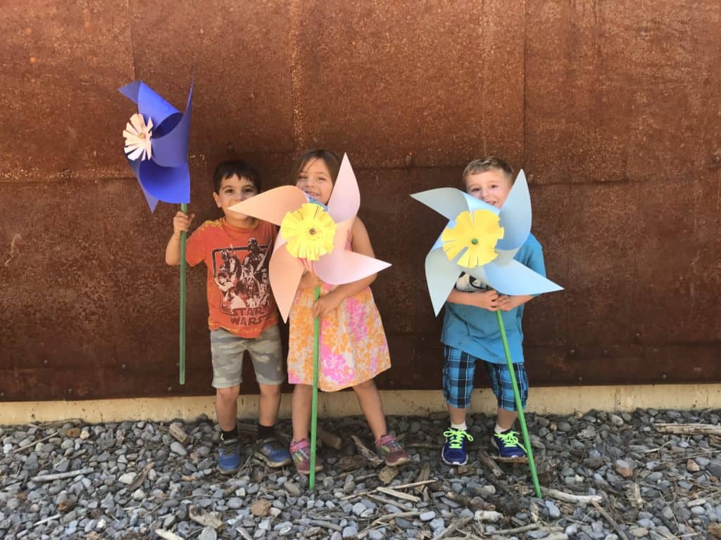 art campers holding giant pinwheels