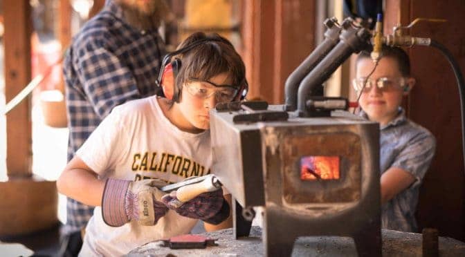 students using a lit forge