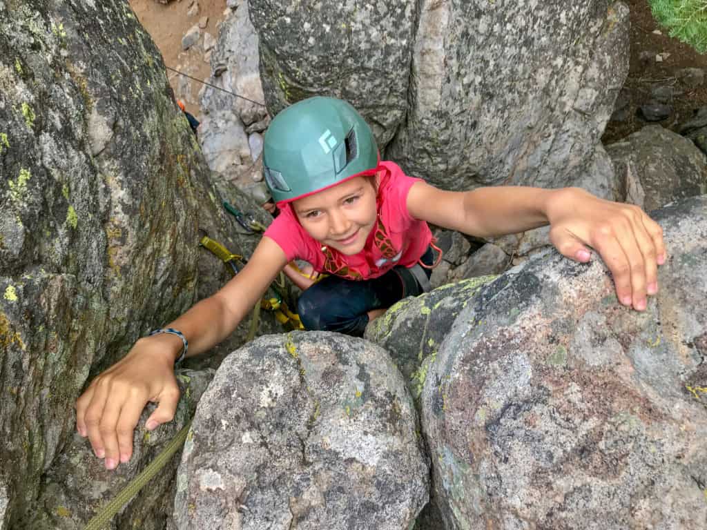 student climbing up rocks