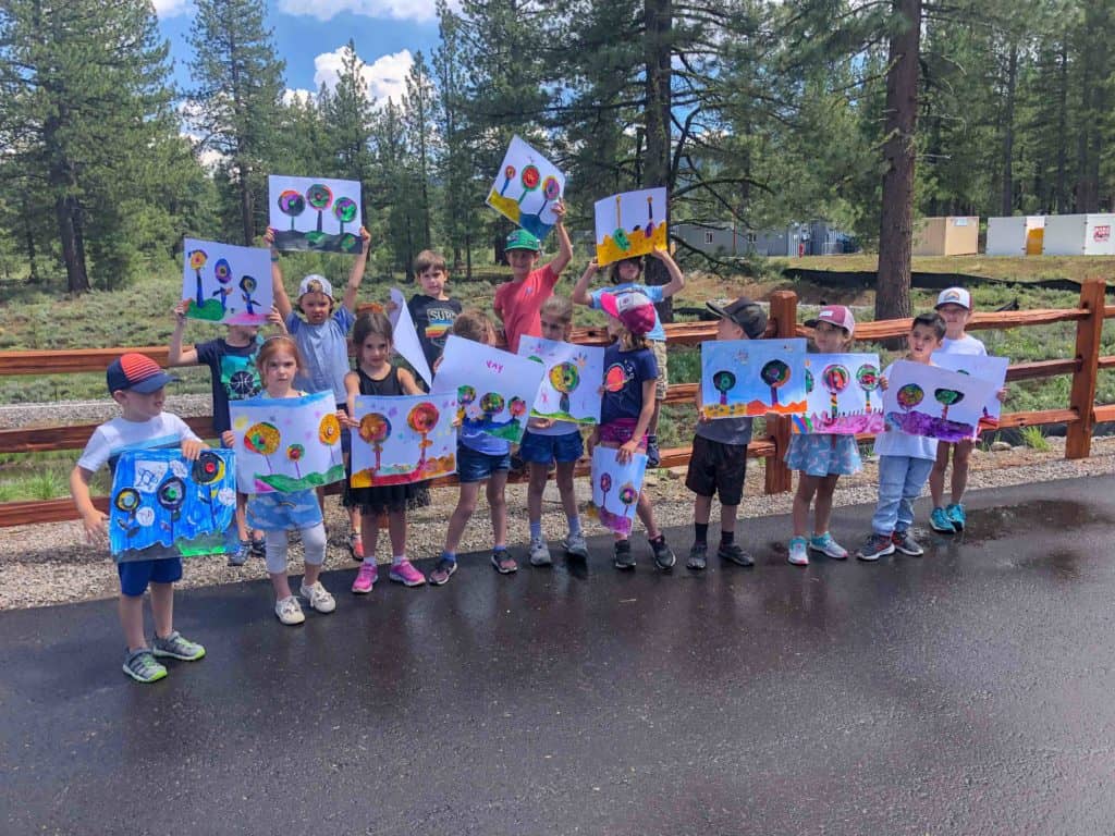 art camp group holding their drawings