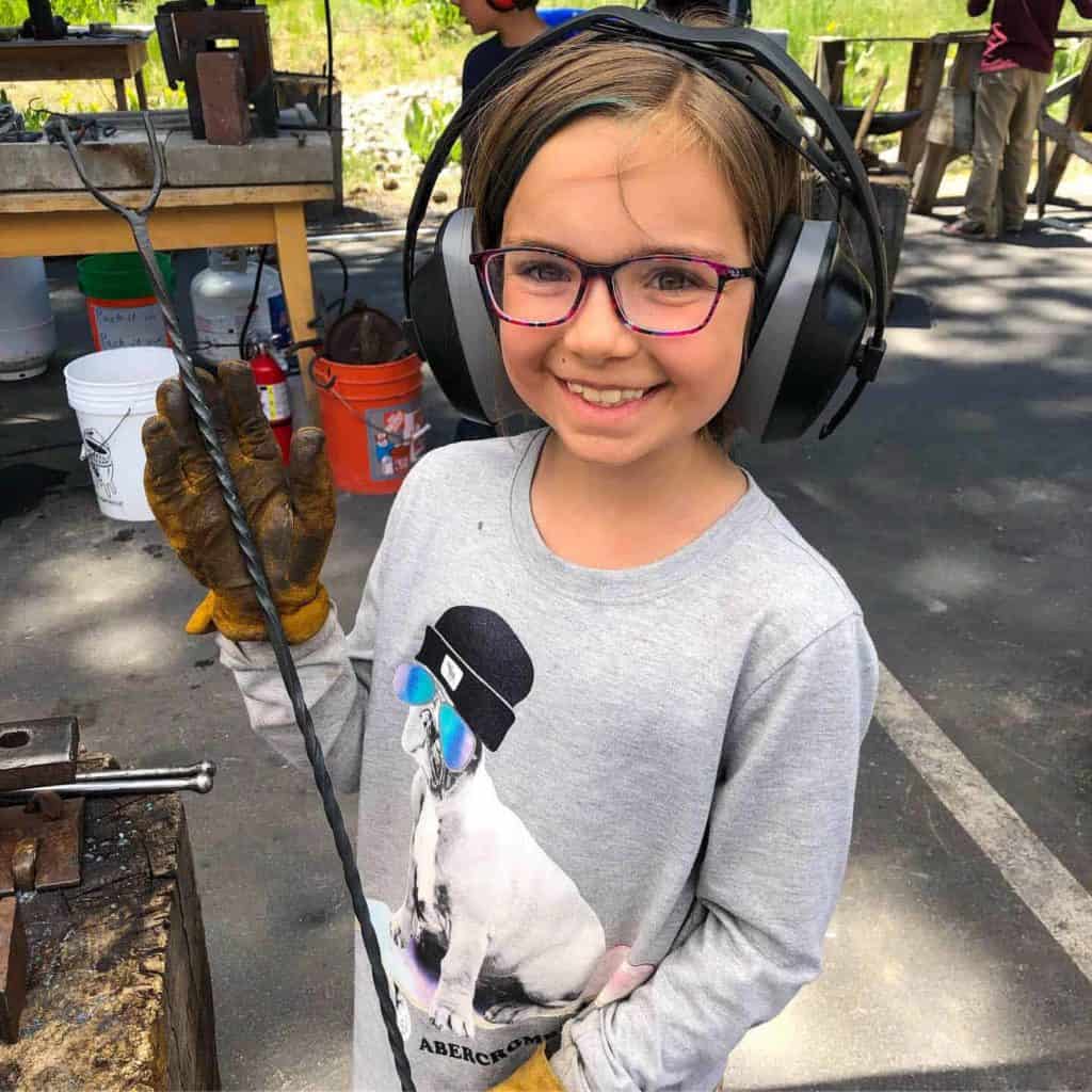 girl in blacksmithing class