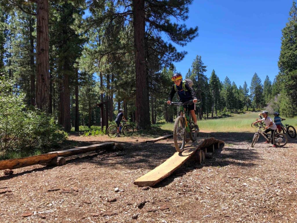 kid riding mountain bike on a trail